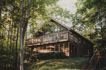 brown wooden house surrounded by green trees during daytime