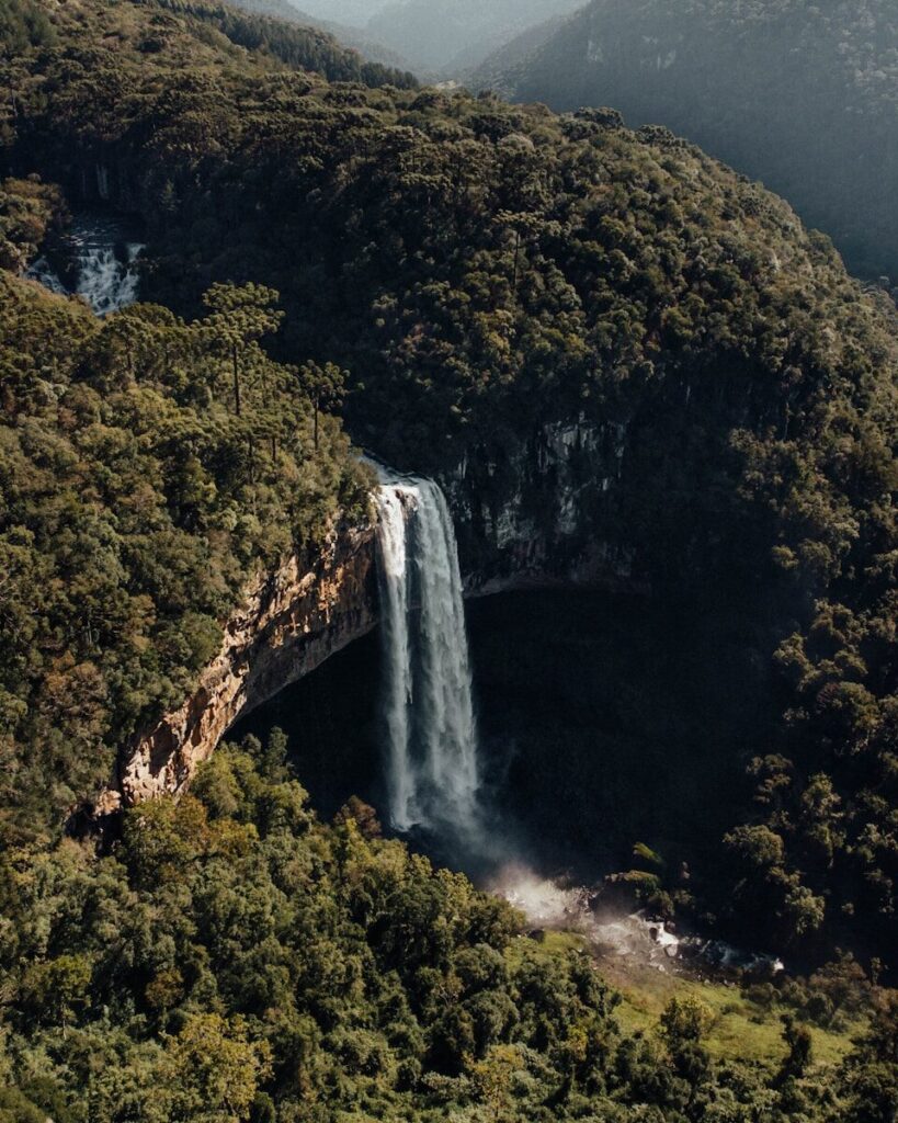a waterfall with a mountain in the background