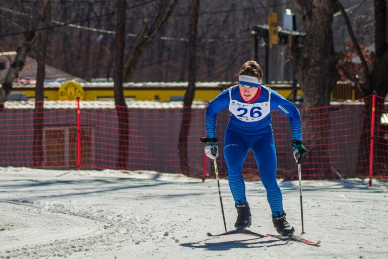 A man riding skis down a snow covered slope